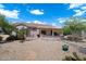 Charming home backyard with covered patio and desert landscaping for low maintenance living at 15313 W Pantano Dr, Surprise, AZ 85374