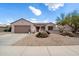 Charming single-story home featuring a xeriscaped front yard with a two-car garage and desert landscaping at 15313 W Pantano Dr, Surprise, AZ 85374