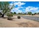 Beautiful view of the community golf course featuring mature trees and desert landscaping at 15313 W Pantano Dr, Surprise, AZ 85374