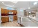 Well-lit kitchen with white appliances, light countertops, and a seamless flow into the bright living area at 15313 W Pantano Dr, Surprise, AZ 85374