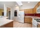Bright kitchen features tile floors, white appliances, and an open layout with seamless flow to living spaces at 15313 W Pantano Dr, Surprise, AZ 85374