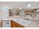 Bright kitchen features tile floors, white appliances, and a breakfast bar open to the living space at 15313 W Pantano Dr, Surprise, AZ 85374