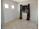 Neutral bedroom featuring natural light, colorful curtains and tile floors at 15507 W Marconi Ave, Surprise, AZ 85374