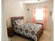 Cozy bedroom featuring patterned bedding, tile floors and a window at 15507 W Marconi Ave, Surprise, AZ 85374