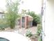 Charming cabana with a thatched roof nestled among lush landscaping in the backyard at 15507 W Marconi Ave, Surprise, AZ 85374