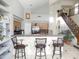 An open kitchen with a breakfast bar, stainless steel appliances, and an adjacent staircase at 15507 W Marconi Ave, Surprise, AZ 85374
