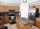 A well-lit kitchen featuring granite countertops, stainless steel appliances, and natural wood cabinetry at 15507 W Marconi Ave, Surprise, AZ 85374