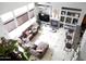Bright, high ceiling living room with large sectional sofa, fireplace, and built-in shelving at 15507 W Marconi Ave, Surprise, AZ 85374