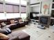 Comfortable living room with a fireplace, tile floors, large sectional and views to the window at 15507 W Marconi Ave, Surprise, AZ 85374