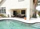 Poolside patio featuring comfortable furniture with a cabana and well maintained landscaping at 15507 W Marconi Ave, Surprise, AZ 85374