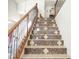 Decorative staircase with a wood and wrought iron banister and tile-accented risers at 15507 W Marconi Ave, Surprise, AZ 85374