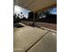 A covered back patio with a concrete floor overlooks the spacious backyard at 15742 W Central St, Surprise, AZ 85374