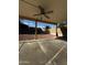 Covered back patio features a ceiling fan, concrete flooring, and a spacious backyard at 15742 W Central St, Surprise, AZ 85374