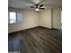 A vacant bedroom features wood-look flooring, white trim, and a window with white shutters at 15742 W Central St, Surprise, AZ 85374
