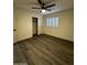 A bedroom with wood-look flooring features a window with shutters and a closet with a white door at 15742 W Central St, Surprise, AZ 85374