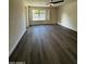 Bright bedroom with hardwood flooring, a ceiling fan, and a window with a view to the outside at 15742 W Central St, Surprise, AZ 85374