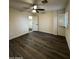 The bedroom features wood-look flooring, a ceiling fan, and a window with white shutters at 15742 W Central St, Surprise, AZ 85374