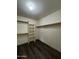 A bright walk-in closet with hardwood flooring and shelving racks on all sides at 15742 W Central St, Surprise, AZ 85374