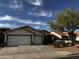 Charming home featuring a two-car garage, desert landscaping and solar panels on the roof at 15742 W Central St, Surprise, AZ 85374