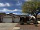 Charming home featuring a two-car garage, desert landscaping and solar panels on the roof at 15742 W Central St, Surprise, AZ 85374