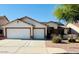 Charming single-story home with a two-car garage, desert landscaping, and solar panels on a clear, sunny day at 15742 W Central St, Surprise, AZ 85374
