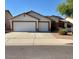 Inviting single-story home featuring a spacious two-car garage and low-maintenance landscaping on a sunny day at 15742 W Central St, Surprise, AZ 85374