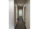 Hallway with several doorways leading to different rooms, lit by recessed lighting at 15742 W Central St, Surprise, AZ 85374
