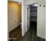Hallway with one door open to a half bathroom and another open to a closet at 15742 W Central St, Surprise, AZ 85374