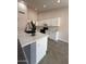 The well-lit kitchen features tall ceilings, granite countertops, a center island and stainless appliances at 15742 W Central St, Surprise, AZ 85374