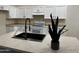 Modern kitchen with stainless steel appliances, light countertops, stylish faucet, and white cabinets at 15742 W Central St, Surprise, AZ 85374