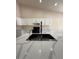 The kitchen is designed with white quartz countertops, a gourmet sink, and modern black appliances at 15742 W Central St, Surprise, AZ 85374