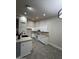 Updated kitchen featuring white cabinets, stainless steel appliances, and a kitchen island with bar seating at 15742 W Central St, Surprise, AZ 85374