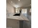 Open kitchen with island bar, sleek quartz countertops, and bright eat-in dining area at 15742 W Central St, Surprise, AZ 85374