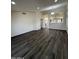 Open living room with hardwood floors, neutral walls, recessed lighting, and views into the kitchen at 15742 W Central St, Surprise, AZ 85374