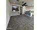 Open floor plan with a view into the kitchen, tile floors, and an adjacent seating area at 15742 W Central St, Surprise, AZ 85374