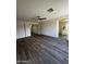 Main bedroom with hardwood floors, bright white trim, and an open doorway to an en suite bathroom at 15742 W Central St, Surprise, AZ 85374