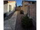 A side yard featuring rock landscaping, a paved walkway, and privacy fencing at 15742 W Central St, Surprise, AZ 85374