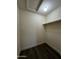 A walk-in closet features wood-look flooring, neutral walls, and a closet rod at 15742 W Central St, Surprise, AZ 85374