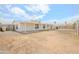 Spacious backyard with gravel landscaping, a covered patio, and a fenced perimeter, perfect for outdoor activities and relaxation at 16008 N 69Th Ln, Peoria, AZ 85382