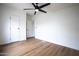 Bedroom features new hardwood floors, a ceiling fan, and a closet at 16008 N 69Th Ln, Peoria, AZ 85382