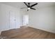 Large bedroom features hardwood flooring, ceiling fan, and a closet at 16008 N 69Th Ln, Peoria, AZ 85382