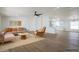 Bright, staged living room with stylish furniture, wood floors, and an open layout to the kitchen, perfect for modern living at 16008 N 69Th Ln, Peoria, AZ 85382