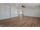 Large open living space with wood floors, built-in shelving, and an open layout to the kitchen, perfect for entertaining at 16008 N 69Th Ln, Peoria, AZ 85382
