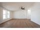 Bright and airy living room with wood flooring and ceiling fan at 16008 N 69Th Ln, Peoria, AZ 85382