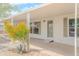 Welcoming porch with desert plants, a covered entrance, and wheelchair ramp, providing both beauty and accessibility at 16008 N 69Th Ln, Peoria, AZ 85382