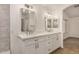 Modern bathroom showcasing a double vanity, quartz counters, updated fixtures, and tiled walls at 16120 N 86Th Ln, Peoria, AZ 85382