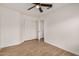 Bright bedroom featuring tile floors, ceiling fan, and a closet with sliding doors at 16120 N 86Th Ln, Peoria, AZ 85382