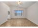 This bedroom features wood-look tile floors, a ceiling fan, and neutral paint at 16120 N 86Th Ln, Peoria, AZ 85382