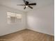 Clean and bright bedroom offering neutral walls, tiled floors, and a ceiling fan at 16120 N 86Th Ln, Peoria, AZ 85382