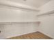 Walk-in closet with shelving and wood-look tile flooring at 16120 N 86Th Ln, Peoria, AZ 85382
